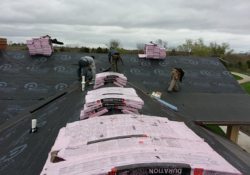 Professional roofing team installing a residential roof in Urbandale, Iowa.